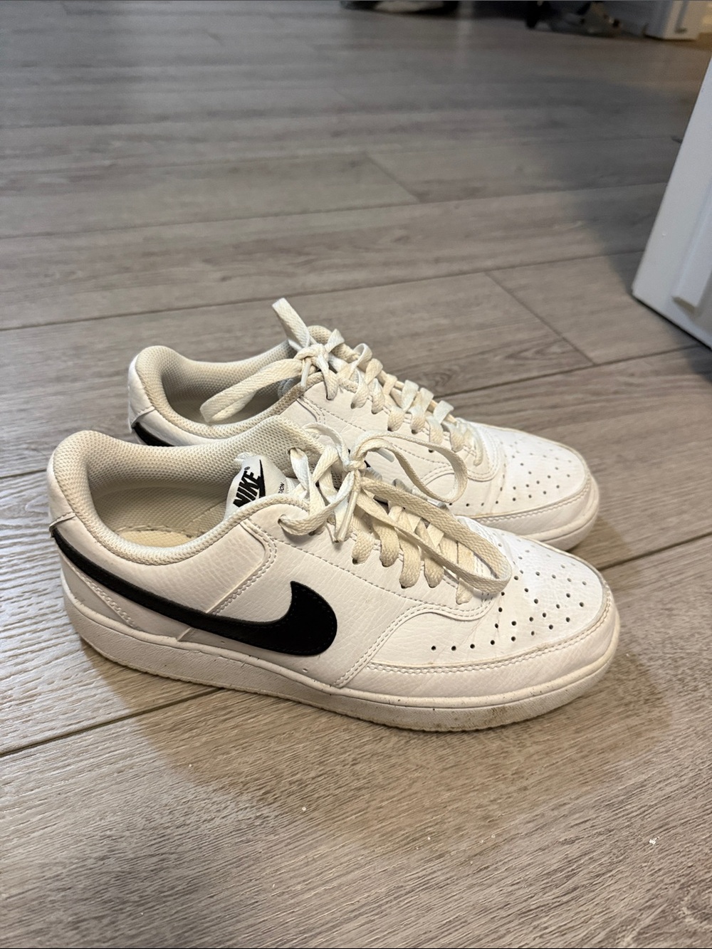 Nike women’s  White Sneakers with Black Swoosh Accent